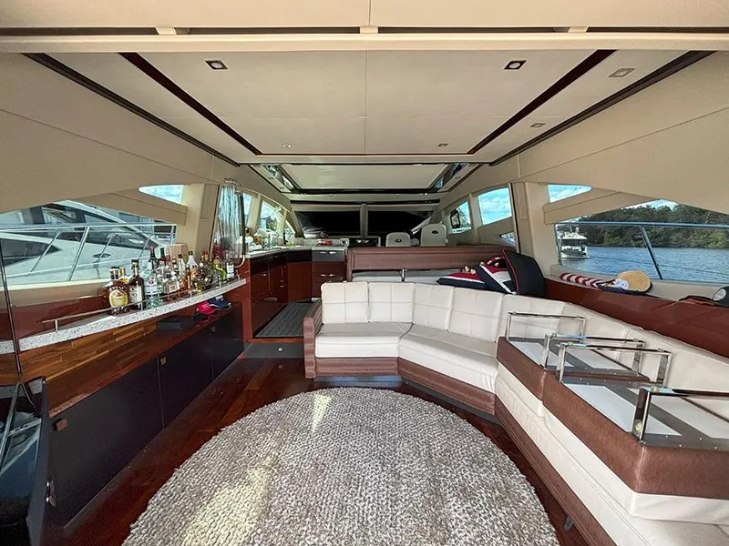 Slide: The Image of Luxurious interior of a 2017 Sea Ray L590 yacht with elegant seating and bar area. - 21