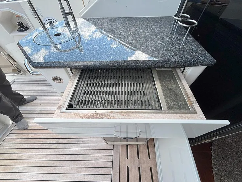 Slide: The Image of Outdoor kitchen on 2017 Sea Ray L590 yacht with grill and granite countertop. - 24