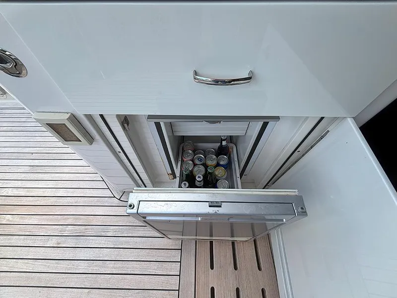 Slide: The Image of Built-in mini fridge on 2017 Sea Ray L590 yacht, stocked with beverages. - 25