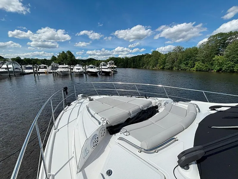 Slide: The Image of 2017 Sea Ray L590 yacht docked on a serene lake under a clear blue sky. - 27