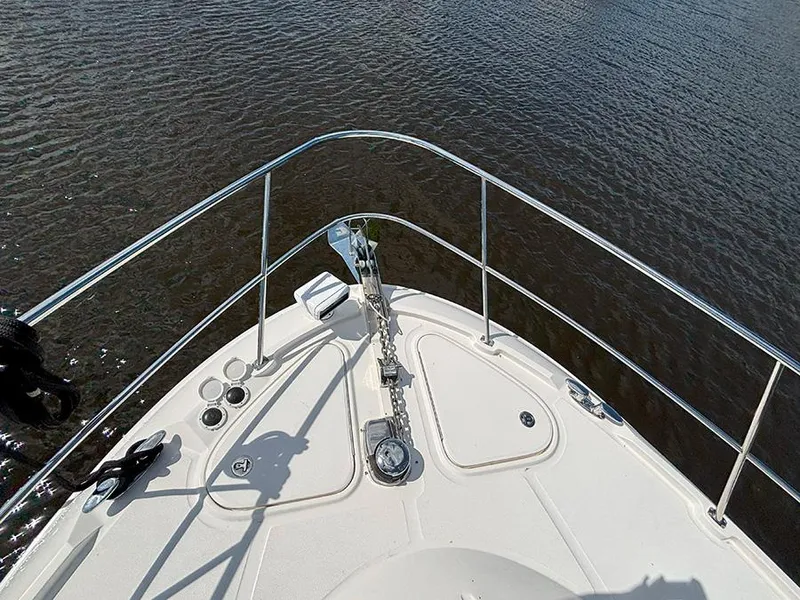 Slide: The Image of 2017 Sea Ray L590 yacht bow with railing, anchor, and calm water view. - 28
