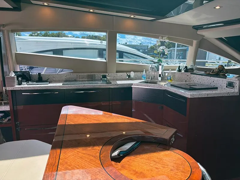 Slide: The Image of Luxurious interior of 2017 Sea Ray L590 yacht with modern kitchen and elegant wood finishes. - 33