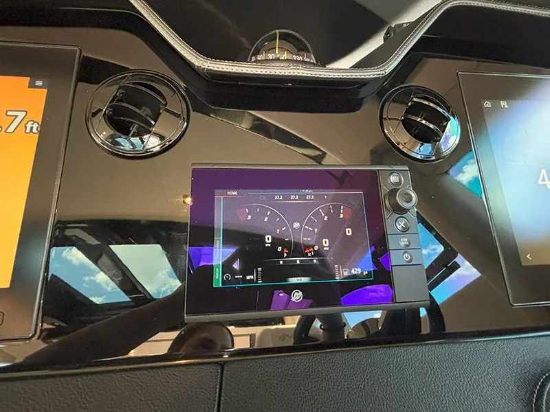 Slide: The Image of Dashboard of a 2017 Sea Ray L590 yacht with digital displays and controls. - 36