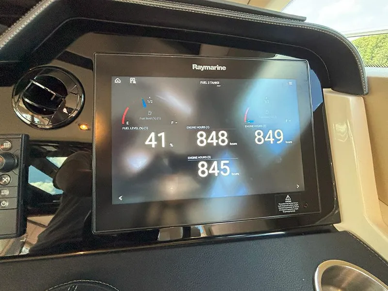 Slide: The Image of Raymarine display on 2017 Sea Ray L590 showing engine hours and fuel levels. - 37