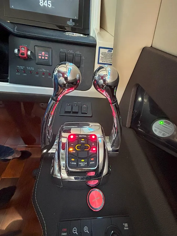 Slide: The Image of Control panel of a 2017 Sea Ray L590 yacht with dual throttle levers. - 39