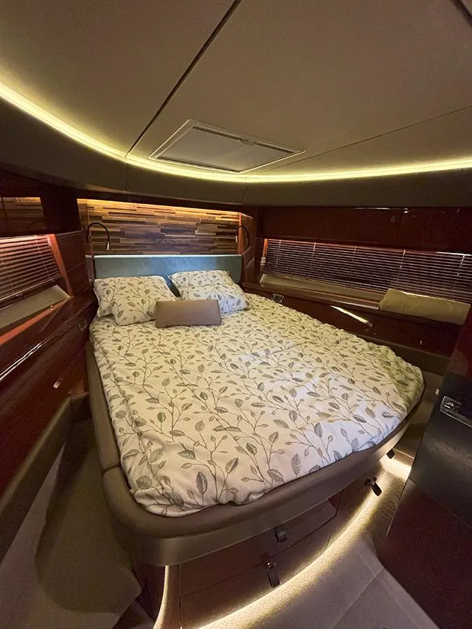 Slide: The Image of Luxurious bedroom interior of 2017 Sea Ray L590 yacht with elegant lighting and bedding. - 41