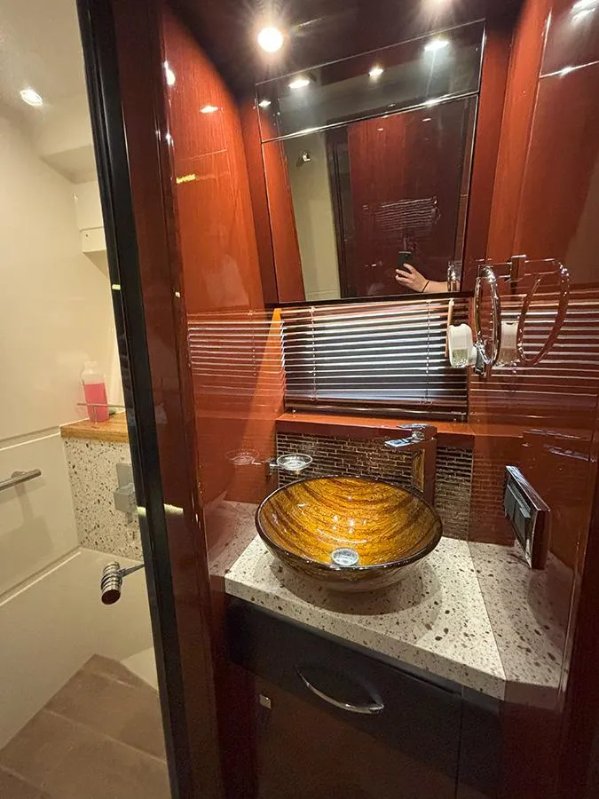 Slide: The Image of Luxurious bathroom in 2017 Sea Ray L590 yacht with elegant vessel sink and modern fixtures. - 43