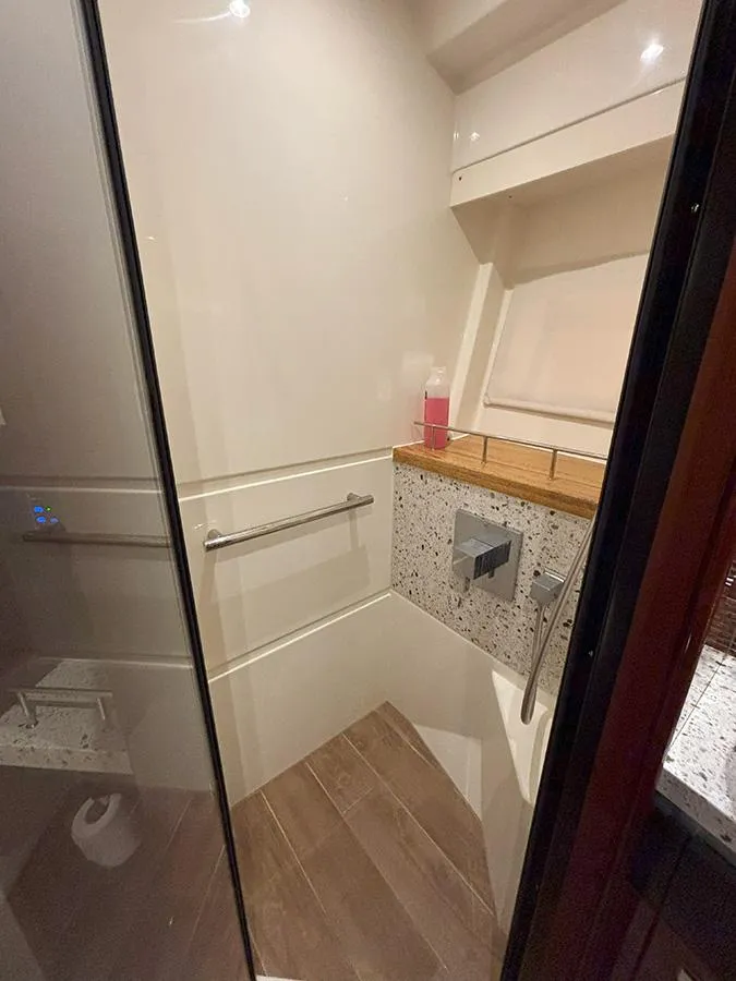 Slide: The Image of Shower area in 2017 Sea Ray L590 yacht with modern fixtures and wooden accents. - 44