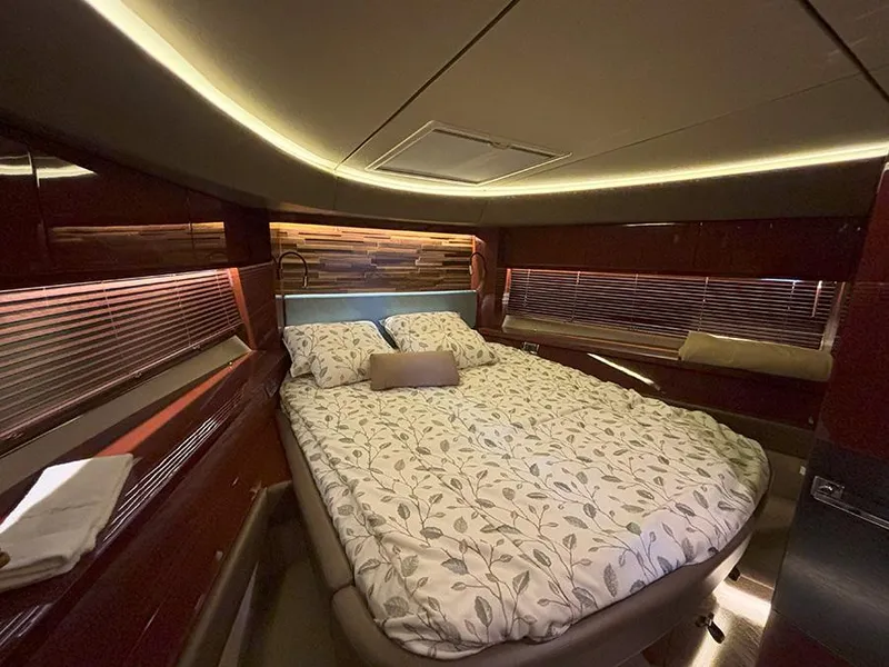 Slide: The Image of Luxurious bedroom interior of 2017 Sea Ray L590 yacht with elegant bedding and ambient lighting. - 5