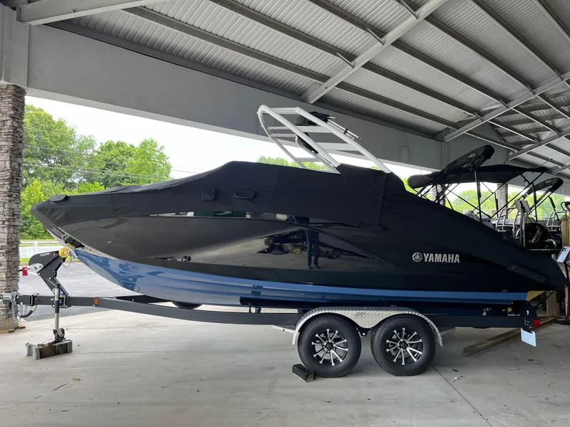 Slide: The Image of 2025 Yamaha Boats 222S under cover on trailer in sheltered area. - 2