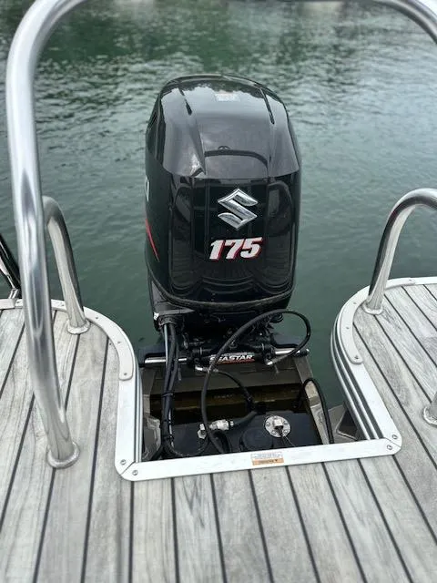 Slide: The Image of 2015 Silver Wave 230 Island CL with Suzuki 175 outboard motor on wooden deck. - 12