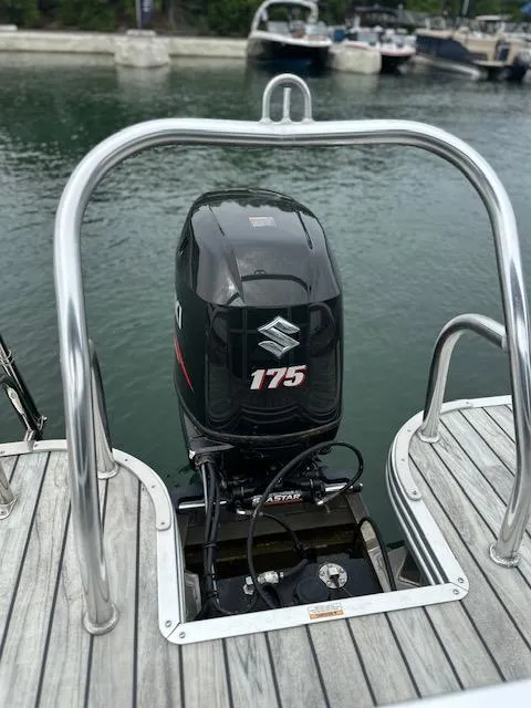 Slide: The Image of Outboard motor on 2015 Silver Wave 230 Island CL pontoon boat at dock. - 13