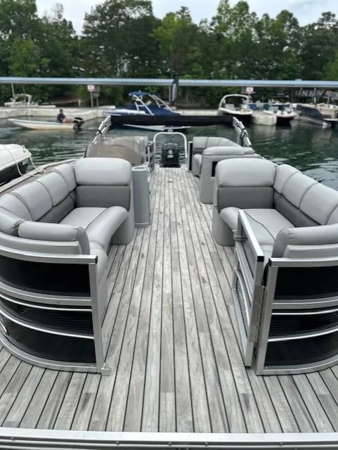 Slide: The Image of 2015 Silver Wave 230 Island CL pontoon boat with spacious seating on a serene lake. - 3