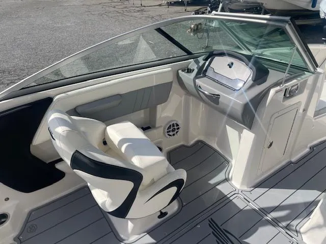 Slide: The Image of 2022 Chaparral 21 Surf boat interior with white seating and speakers. - 10