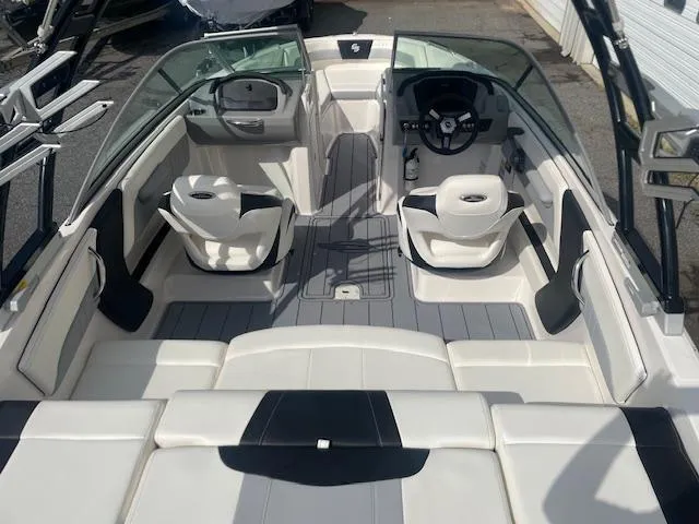 Slide: The Image of 2022 Chaparral 21 Surf boat on trailer, parked outside a warehouse. - 4