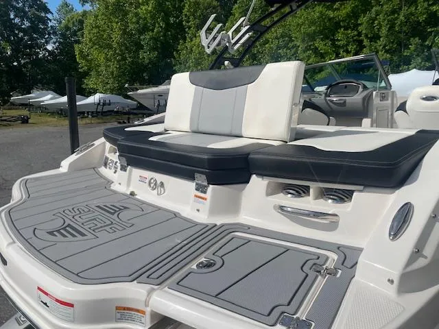 Slide: The Image of 2022 Chaparral 21 Surf boat with white and gray cushioned seating. - 6