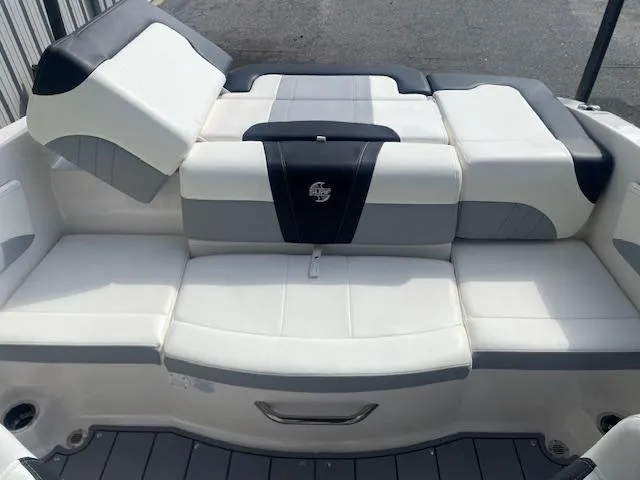 Slide: The Image of 2022 Chaparral 21 Surf boat interior with white and gray seating. - 8