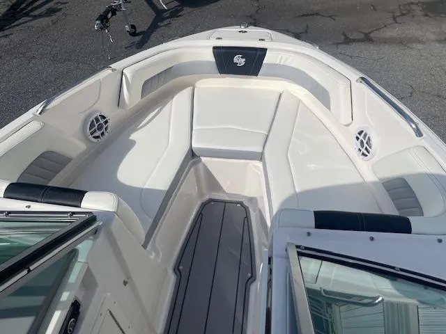 Slide: The Image of 2022 Chaparral 21 Surf boat interior with white and gray seating. - 9