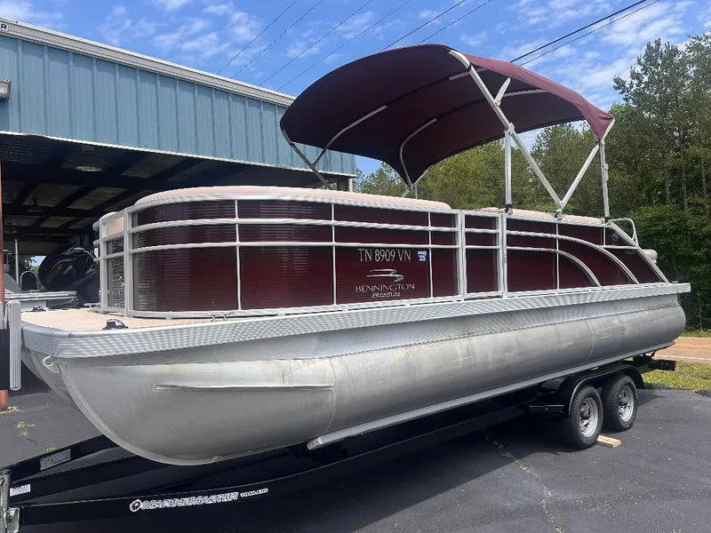 Slide: The Image of 2018 Bennington 23SSBXP pontoon boat with Yamaha F150 engine on trailer. - 0