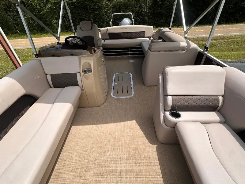 Slide: The Image of 2018 Bennington 23SSBXP pontoon boat interior with beige seating and Yamaha F150 engine. - 11