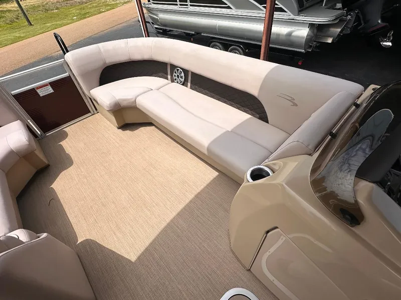 Slide: The Image of 2018 Bennington 23SSBXP boat interior with beige seating and carpet flooring. - 12