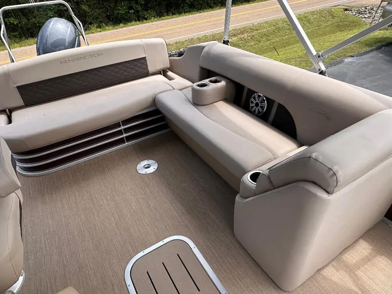 Slide: The Image of 2018 Bennington 23SSBXP boat interior with beige seating and Yamaha F150 engine. - 9
