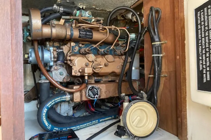 Slide: The Image of Engine compartment of a 1981 Sea Sprite 34 sailboat, showcasing mechanical components and wiring. - 10