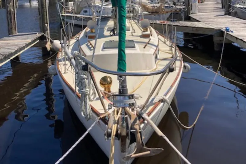 Slide: The Image of 1981 Sea Sprite 34 sailboat docked at marina, front view with ropes and anchor. - 4