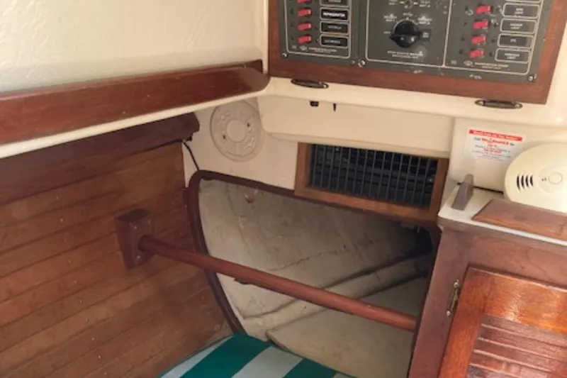 Slide: The Image of Interior of a 1981 Sea Sprite 34 sailboat, featuring wood paneling and control panel. - 5