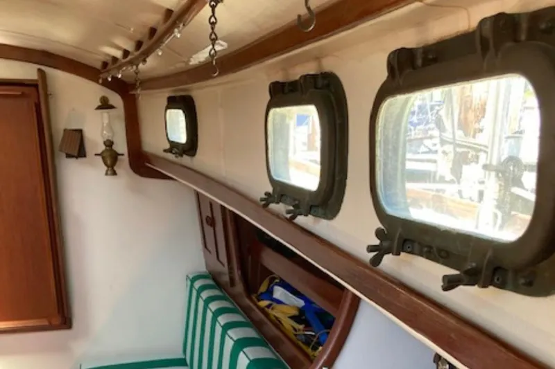Slide: The Image of Interior of 1981 Sea Sprite 34 sailboat with portholes and striped seating. - 8