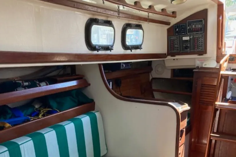 Slide: The Image of Interior of 1981 Sea Sprite 34 sailboat with wood paneling and striped seating. - 9