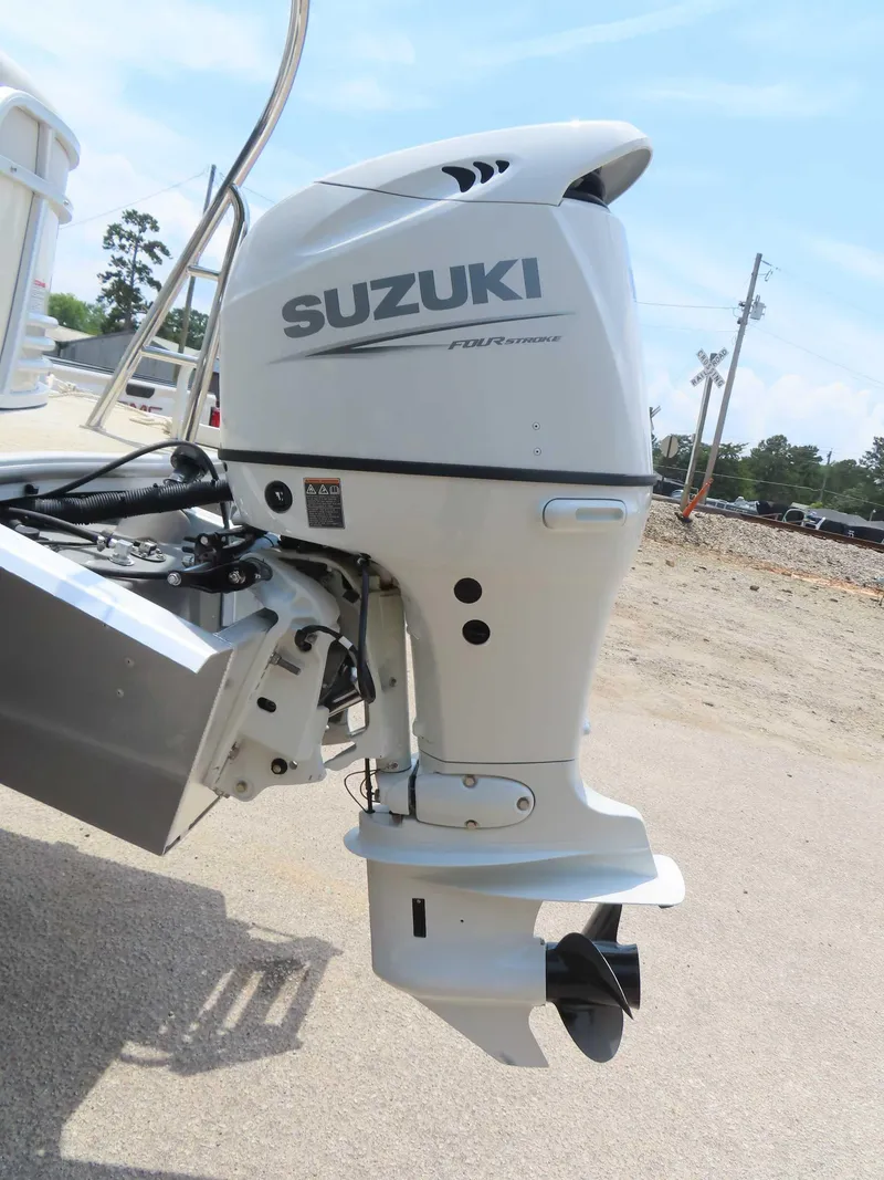 Slide: The Image of 2022 Nepallo pontoon with Suzuki four-stroke outboard motor, parked on a sunny day. - 10