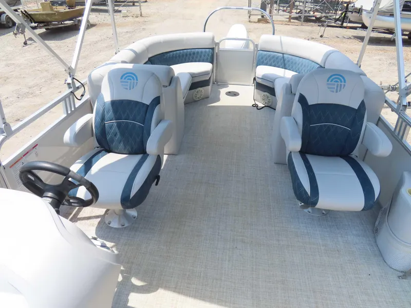 Slide: The Image of 2022 Nepallo pontoon boat interior with plush seating and steering wheel. - 15