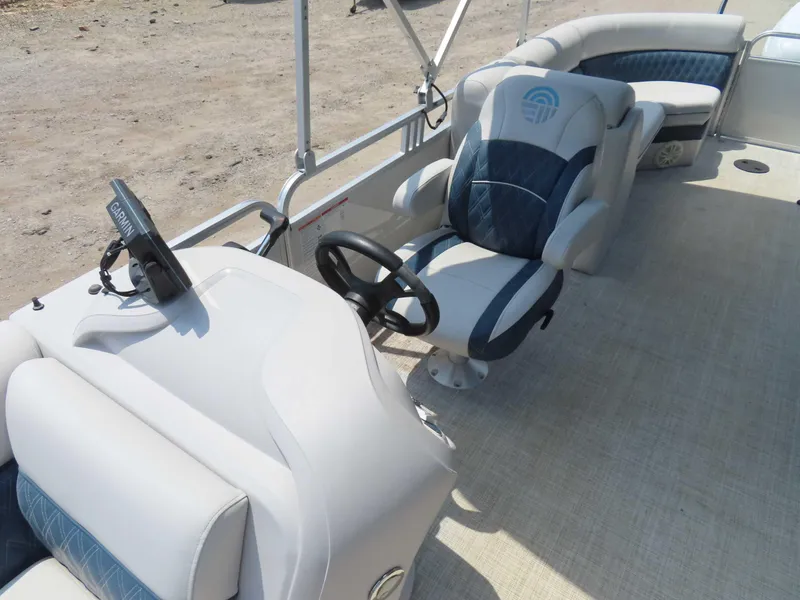 Slide: The Image of 2022 Nepallo pontoon boat interior with steering wheel and Garmin navigation system. - 17