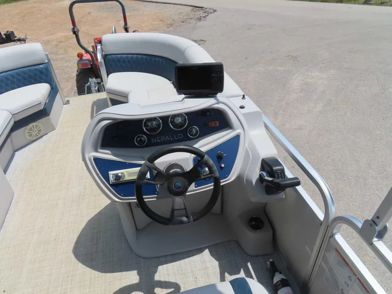 Slide: The Image of 2022 Nepallo pontoon boat dashboard with steering wheel and controls. - 20