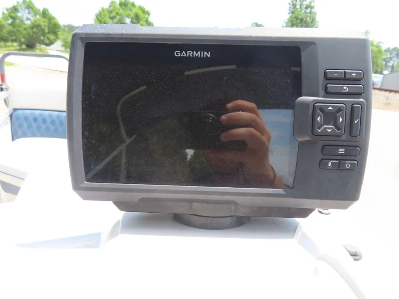 Slide: The Image of Garmin device on 2022 Nepallo pontoon boat dashboard, reflecting surroundings. - 21