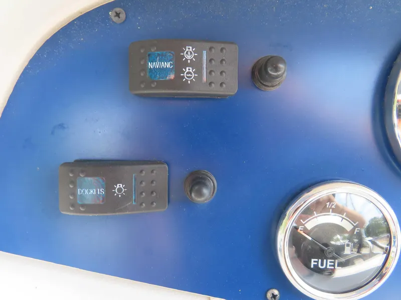 Slide: The Image of Control panel of a 2022 Nepallo pontoon with switches and fuel gauge. - 25