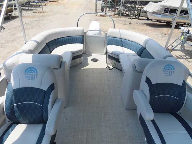 Slide: The Image of 2022 Nepallo pontoon boat interior with blue and white seating, docked on a sunny day. - 29