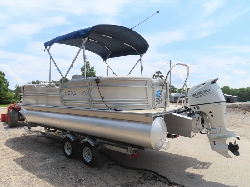 Slide: The Image of 2022 Nepallo pontoon boat with Suzuki outboard motor on trailer, under blue sky. - 5