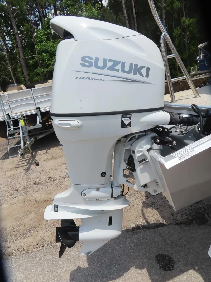 Slide: The Image of 2022 Nepallo pontoon with Suzuki four-stroke outboard motor in a wooded area. - 9