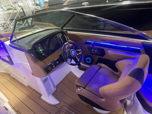 Slide: The Image of 2025 Chaparral 267 SSX boat interior with modern dashboard and luxurious seating. - 10
