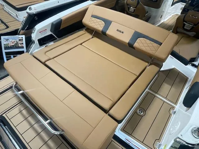 Slide: The Image of 2025 Chaparral 267 SSX boat interior with tan leather seating and sleek design. - 5