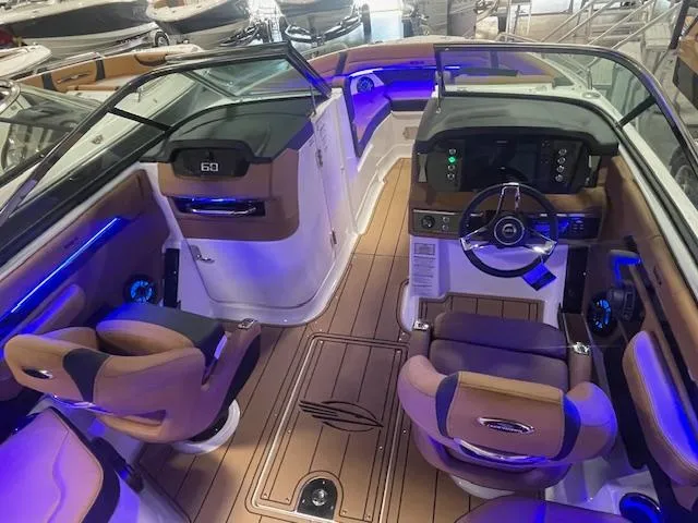 Slide: The Image of 2025 Chaparral 267 SSX boat interior with modern dashboard and ambient lighting. - 8