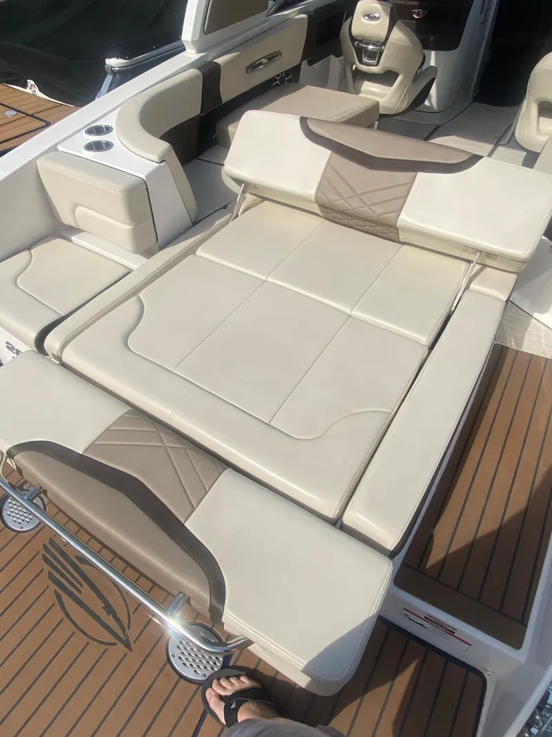 Slide: The Image of 2018 Chaparral 267 SSX boat interior with beige seating and teak flooring. - 10
