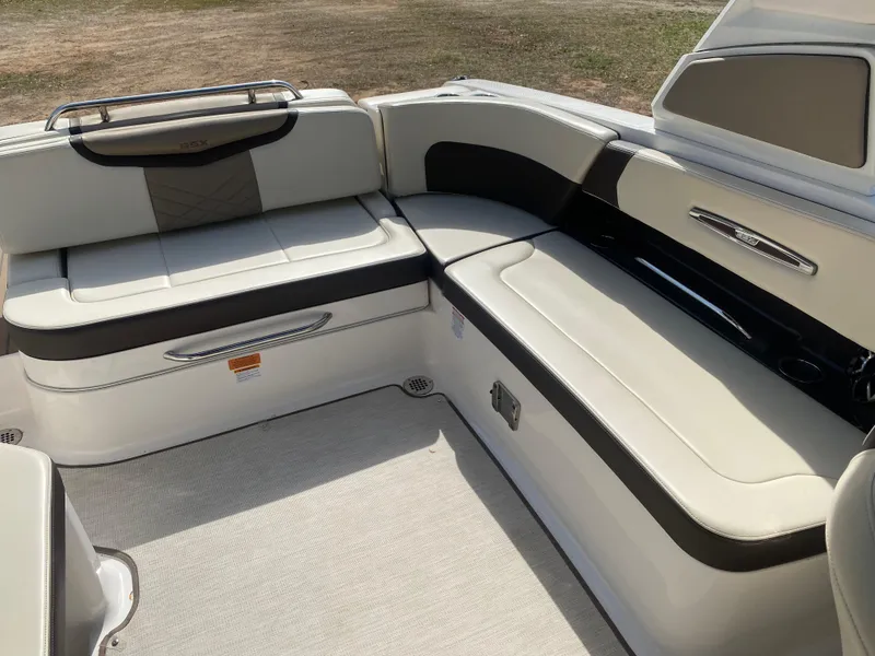 Slide: The Image of 2018 Chaparral 267 SSX boat interior with sleek, modern seating in white and black. - 11