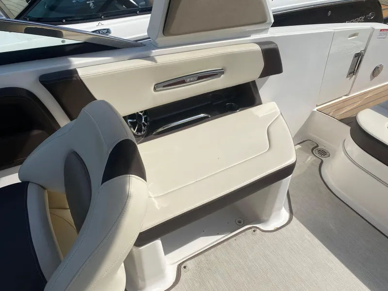 Slide: The Image of 2018 Chaparral 267 SSX boat interior with beige and black seating. - 13