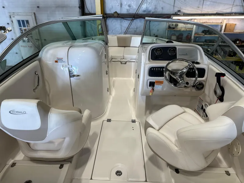 Slide: The Image of 2019 Robalo R207 Dual Console boat interior with white seating and steering console. - 10