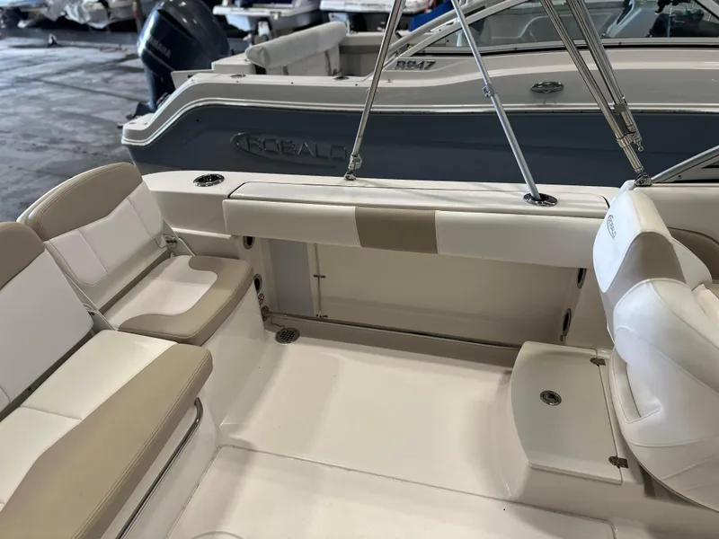 Slide: The Image of 2019 Robalo R207 Dual Console boat interior with beige seating and white accents. - 13