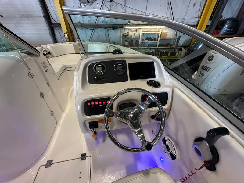 Slide: The Image of 2019 Robalo R207 Dual Console boat interior with steering wheel and control panel. - 22