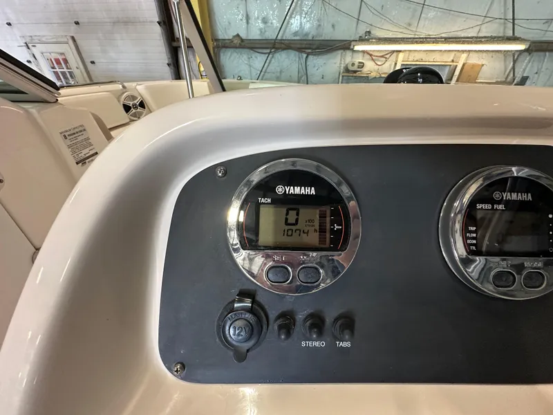 Slide: The Image of Dashboard of 2019 Robalo R207 Dual Console with Yamaha gauges in a garage setting. - 23